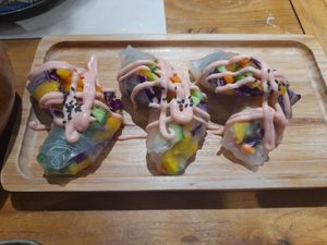 Rice skins encasing cucumber, pepper, red cabbage and mango - delicious. 
Vegetarian. Could be vegan without sauce. 

Around 20-25rmb. at WángYǔYān Sù Fāng 王语嫣素坊 in Dali