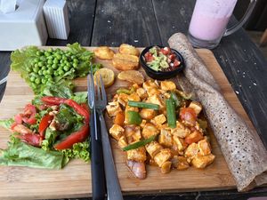 Tofu with salad, fresh peas roasted potatoes, salad and guacamole. at Little Windows in Pokhara