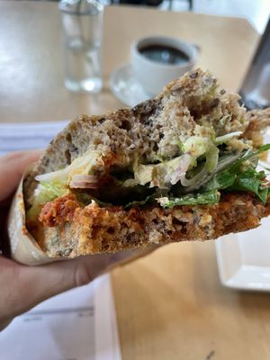 Vegan sandwich: hummus, sun dried tomato, avocado and olive  at Godt Brød in Stavanger