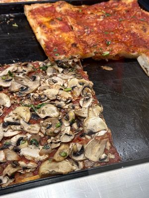 Another mushroom pizza with the spicy tomato sauce pizza in the back   at Alice in Lucca