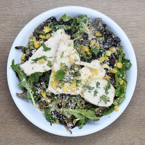 The Grain Go - Organic Greens, Purple Cabbage, Quinoa, Roasted Corn, Red Onion, Black Beans, Jalapeno, Cotija, Chicken, Cilantro Agave Lime Vinaigrette at Revel Kitchen in Clayton