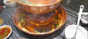 Cooking vegetables in the hotpot at Yangege 焱格格蔬食料理火锅 in Shanghai