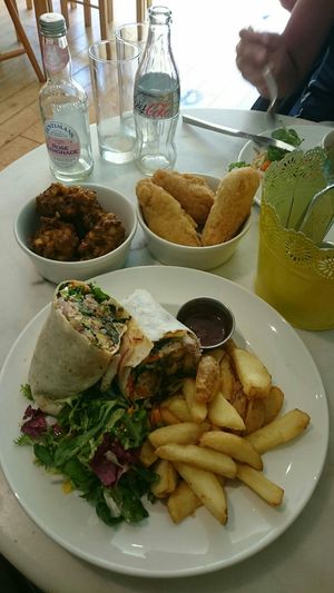 Jerk burrito wrap. With extra corn fritters and Festivals (Like savory donut sticks) at Mama Fay's in Aberystwyth