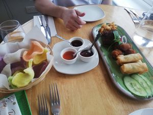 Vegan starter platter - prawn crackers, spring rolls, fried tofu bites, bruschetta, and parcels with sauce selection at Hoi-An in Bodmin