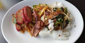 Char siu pork and the black bean with chili beef mixed together on a plate at Hoi-An in Bodmin