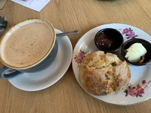 Decaf oat milk cappuccino and vegan scone with jam and butter  at Glass Onion in Liverpool