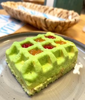 Vegan Pistachio cake: puffed rice, vegetable cream, pistachio sauce, cocoa velor, raspberry and peach jam. at Garun in Yerevan