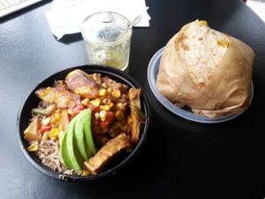 BBQ tofu dish on the left. Large roti with all 3 fillings (curried chickpeas and potatoes, curried TVP, and seasoned Jamaican pumpkin) on the right. VERY yummy. at One Love Vegetarian in Toronto