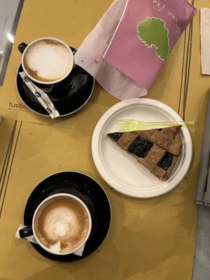 Coconut latte on top, soy latte bottom + berries tart 😍  at Cuore Fresco in Catania