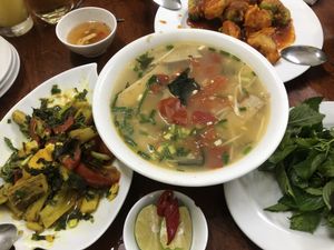Seafood noodles, banana tomato dish, fried cauliflower and broccoli  at Hà Thành in Hanoi