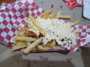 Fries topped with fried cheese; the cheese did not stick to the fries - it lifted off in a single piece, and was nicely browned on one side.  Both components were delicious. at Rincón Veggie in Mexico City