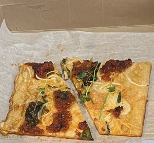 This was the vegan slice special yesterday- vegan mozz, pea shoots, salsa Rosa, and some other goodness. Uniquely delicious!!  at Monte's Fine Foods in Portland