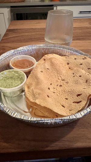 Pappadam with fire roasted tomato chutney(nice heat) cilantro sauce(nice spiciness and verifies with kitchen it’s vegan)  at Utara Brewing Co in Sandpoint
