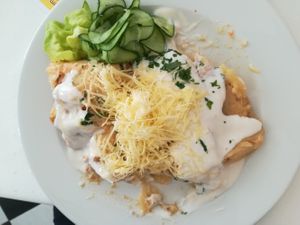 Layered potatoes and VG cheese with cucumber salad at Napfényes Restaurant & Confectionery in Budapest