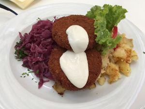 Oat fritters with cabbage and mashed potatoes at Napfényes Restaurant & Confectionery in Budapest