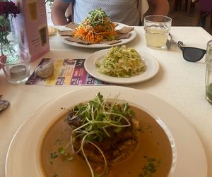 Teriyaki tofu on rice.  Middle is home made cabbage.  Far side of the photo is a raw plate.  All really good.    at Napfényes Restaurant & Confectionery in Budapest