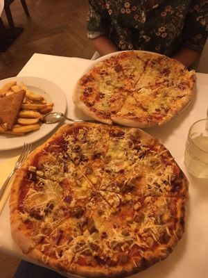 Pizzas, steak fries and breaded fried cheese at Napfényes Restaurant & Confectionery in Budapest
