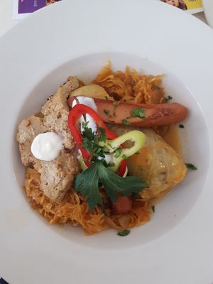 Stuffed cabbage with seitan cutlet and soy dog on a bed of sauerkraut at Napfényes Restaurant & Confectionery in Budapest