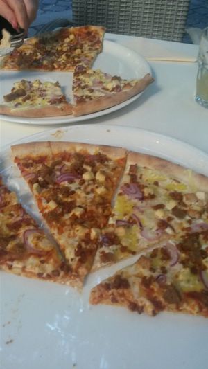 Vegan pizza with tofu. One with tomato base and one with a creamy base at Napfényes Restaurant & Confectionery in Budapest