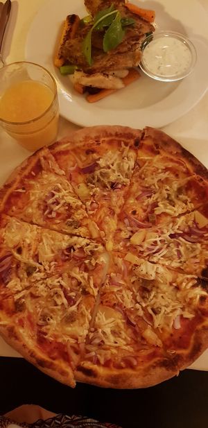 Hawaii pizza with no corn and extra onion at Napfényes Restaurant & Confectionery in Budapest