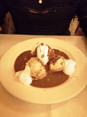 Sponge cake with chocolate sauce and whipped cream. at Napfényes Restaurant & Confectionery in Budapest