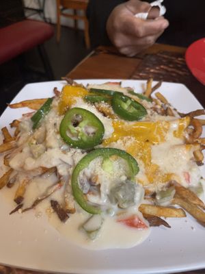 Fries covered in cheese and jalapeños   at Souley Vegan in Oakland