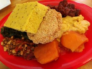 Half of sampler platter. Yams, southern fried tofu, BarBQ tofu, corn bread, lentils, black eyed peas, Mac & cheese at Souley Vegan in Oakland