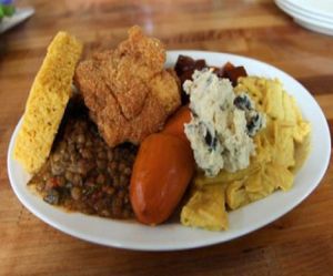 he everything plate: collard greens, cornbread, black eye peas, southern fried tofu, lentils, potato salad, bbq tofu, mac-n-cheese, and yams at Souley Vegan in Oakland