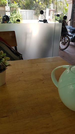 Leftover dishes finally removed! Still a gross table though. at Zhu Lin Xuan House in Siem Reap