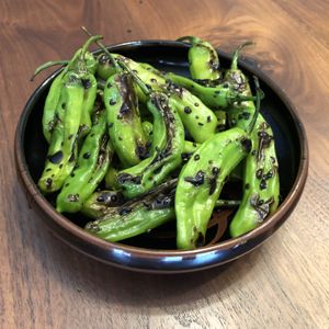 Blistered Shishito Peppers with Tamari Glaze and Sesame Seeds at Queen & Rook Game Cafe in Philadelphia