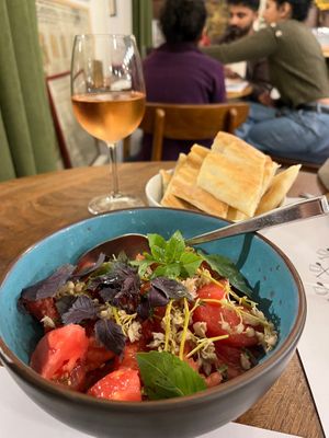 Tomato salad with pickled jonjoli (buds of caucasian bladdernut), herbs, and Kakhetian sunflower seed oil. at Salobie Bia in Tbilisi