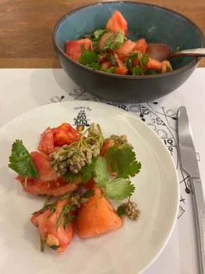 Tomato salad with pickled jonjoli (buds of caucasian bladdernut), herbs, and Kakhetian sunflower seed oil. at Salobie Bia in Tbilisi