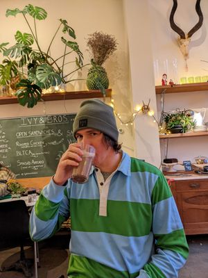 Hot chocolate with espresso, menu behind. at Ivy and Bros in Amsterdam