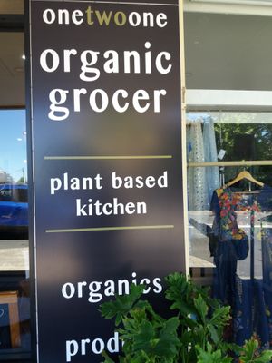 Outside signage at 1Two1 Vegan Café in Springwood