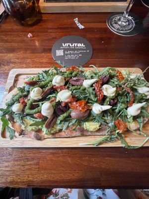 Flatbread with avocado, sundried tomato, olives, arugula, and a creamy "cheese”  at Blu Bar in Barcelona