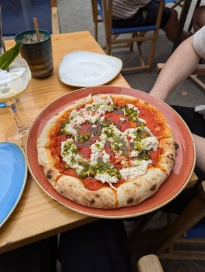 Stracciatella pizza with tomato sauce, vegan stracciatella cheese, pistachios and basil oil at Blu Bar in Barcelona