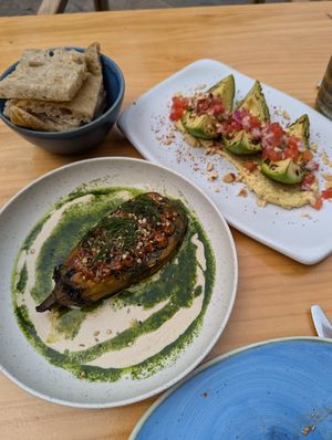 "Berenjena gourmet": roasted eggplant, peanut sauce, tahini sauce, mixed seeds and dill + "Next level avocado: toasted avocado, served with hummus, tomato, red onion, Tajín Clási at Blu Bar in Barcelona