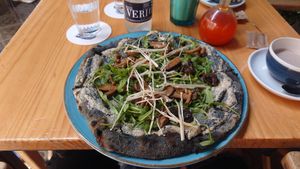 Activated charcoal pizza with truffle and mushrooms at Blu Bar in Barcelona