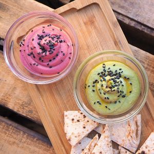 DELICIOUS DOUBLE HUMMUS  	
spinach hummus and betroot hummus with pita bread and carrots 	 at Blu Bar in Barcelona