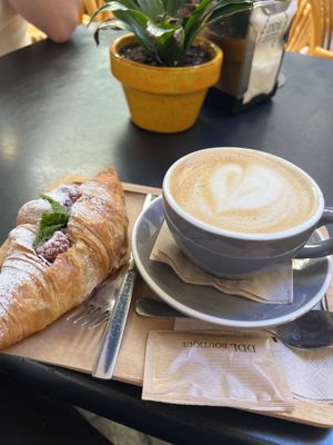 Vegan raspberry croissant and oat lattee  at Dulce de Leche - Boutique San Vicente in Valencia
