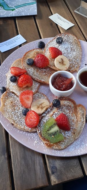 Pancakes with maple syrup, fruit and confiture at Cytat Cafè in Krakow