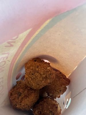 Close-up of takeaway Mac and cheese vegan bites at LEON - Norton Canes in Cannock