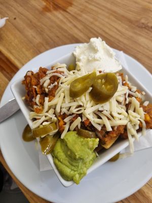 Vegetarian sweet potato and lentil chilli nachos. Can be made VG without the cheese and sour cream at Laggan Wolftrax Cafe in Laggan