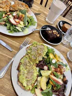 Avo toast with salad, humus toast with salad, brownie, orange cinnamon cake, smoothie of the day.  at Virgule in Toulouse