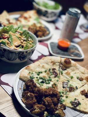 Carbonara pizza, curried cauliflower, and ensalada andalusia  at Wildseed in San Francisco