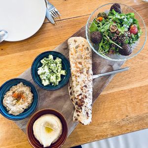 Green falafel, smoked white bean hummus, baba ghanoush, marinated feta, seeded flatbread, and quinoa salad with pomegranate vinaigrette  at Wildseed in San Francisco
