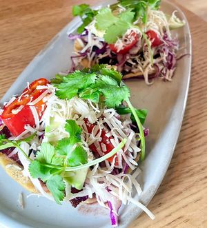 Beet Tostadas: sikil pak, black beans, beets, cabbage, avocado, fresno chile, coconut parmesan, and cilantro  at Wildseed in San Francisco