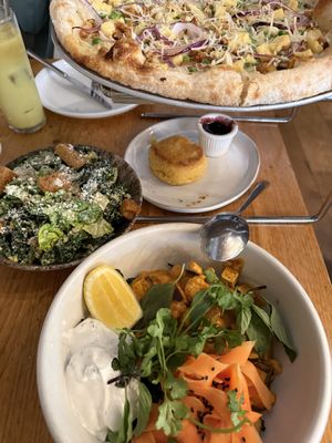 brunch pizza, biscuit, caesar salad, mezze bowl   at Wildseed in San Francisco