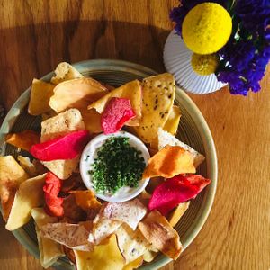 Harissa-spiked vegetable chips with sour cream and onion dip  at Wildseed in San Francisco
