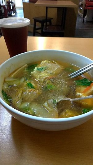Glass noodle soup with traditional Taiwanese red tea on the side. at SùShí GuǎngDōng Zhōu 素食廣東粥 in Kaohsiung